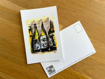 Carte postale " 4 Bouteilles de saké avec personnage qui tire la langue "