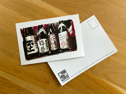 Carte postale " 4 bouteilles de saké fond rouge "